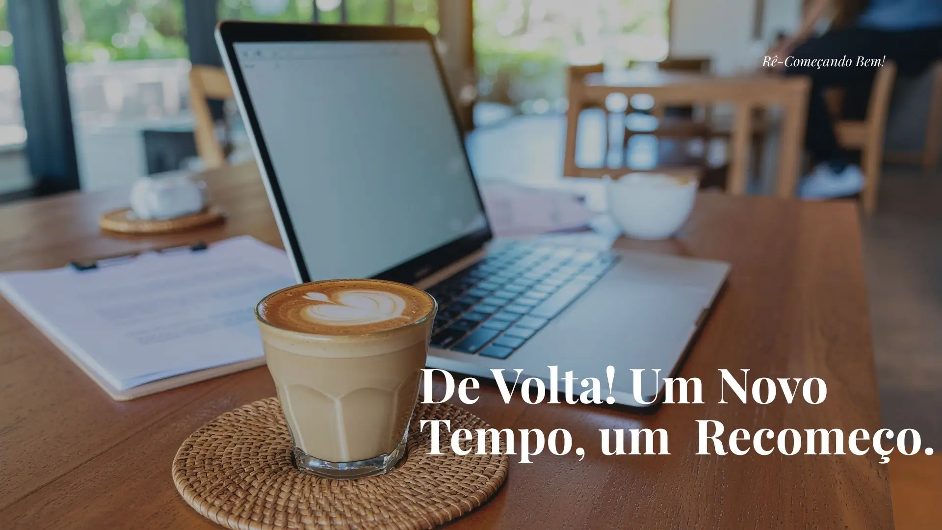 Uma escrivaninha com uma xícara de café e um notebook.